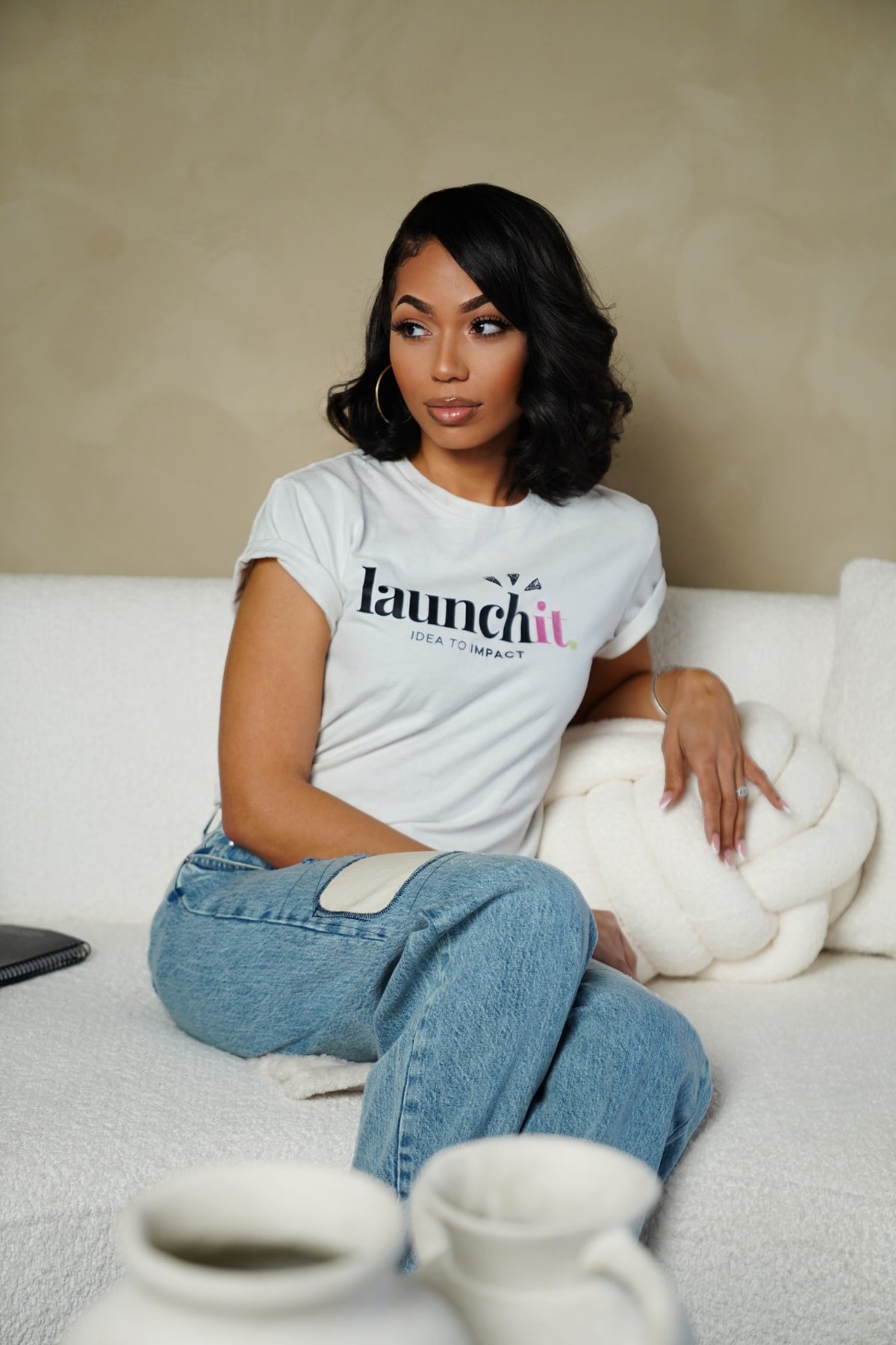 Chadé Lopez seated in the studio wearing her Launch It Agency shirt